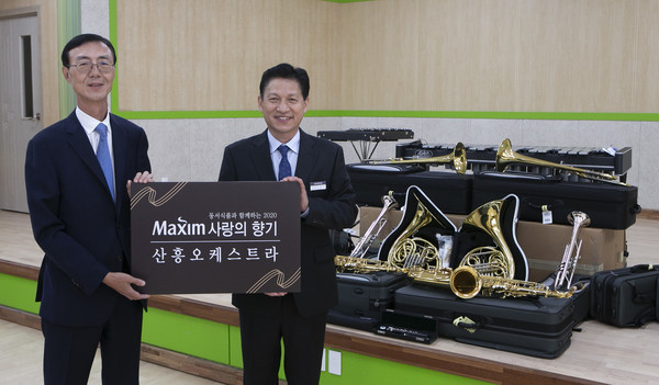 ▲27일 대전광역시 동구에 위치한 산흥초등학교에서 진행된 ‘제13회 맥심 사랑의 향기’ 악기 기증식에서 동서식품 최상인 홍보상무(왼쪽)와 산흥초등학교 김완구 교장(오른쪽)이 기념촬영을 하고 있다.