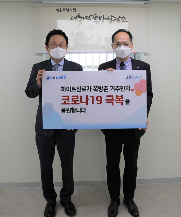 ▲하이트진로 류준형 상무(왼쪽)는 서울역 쪽방상담소에서 김갑록 소장을 만나 쪽방촌 거주민을 위한 마스크(KF-94)를 전달했다. 